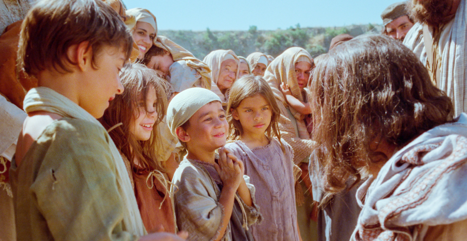 Jesus talks with children.